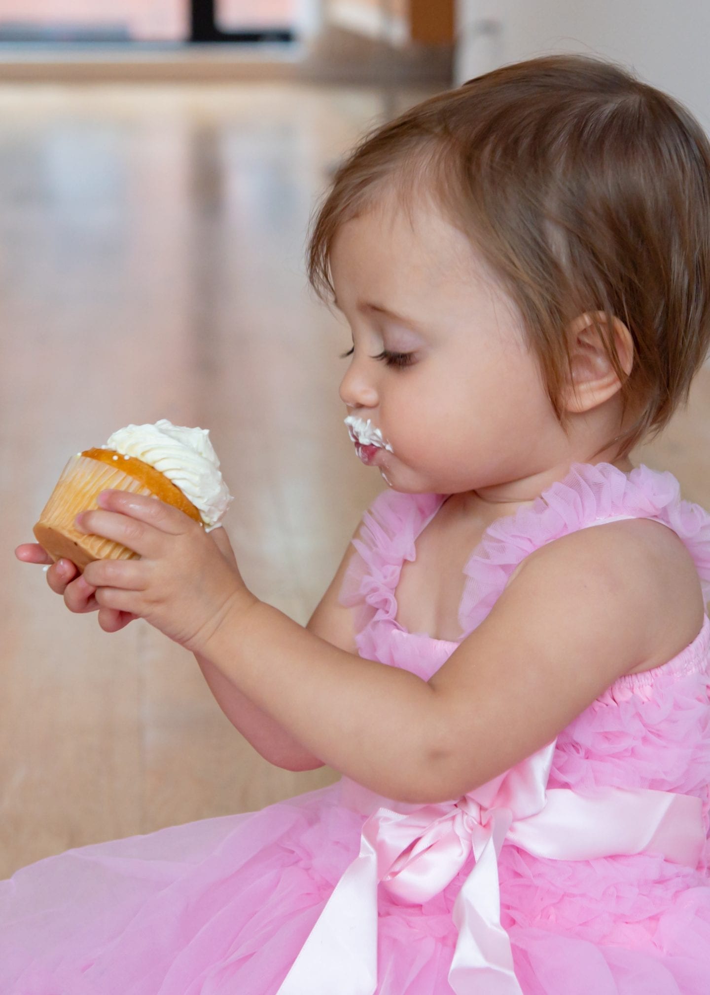 5 Essentials for an Unforgettable First Birthday Photoshoot at Home First Birthday Photoshoot. First Birthday Photoshoot Ideas. Pink Rufflebutts Dress. Cupcake Smash.