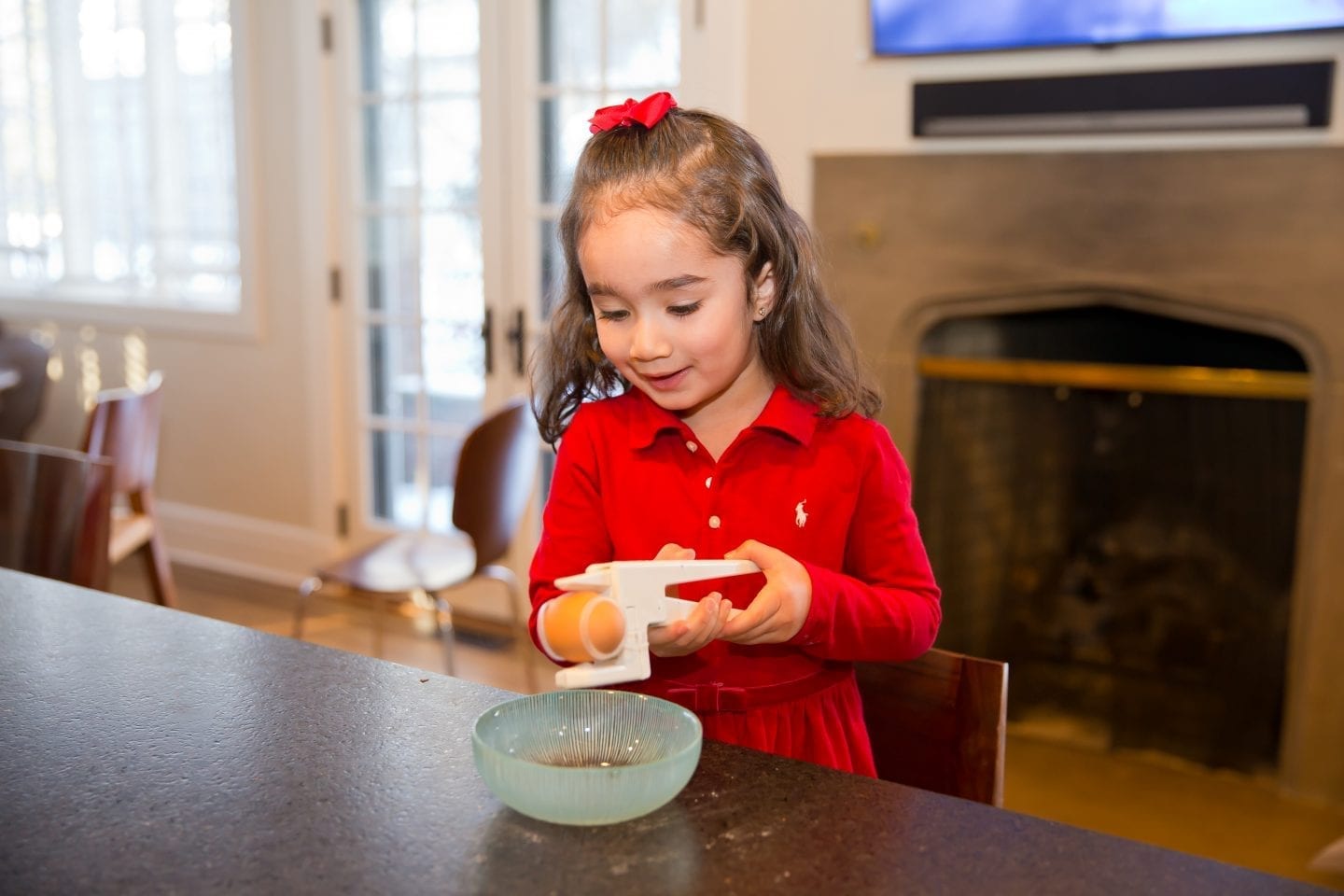 Kids cooking with egg cracker 