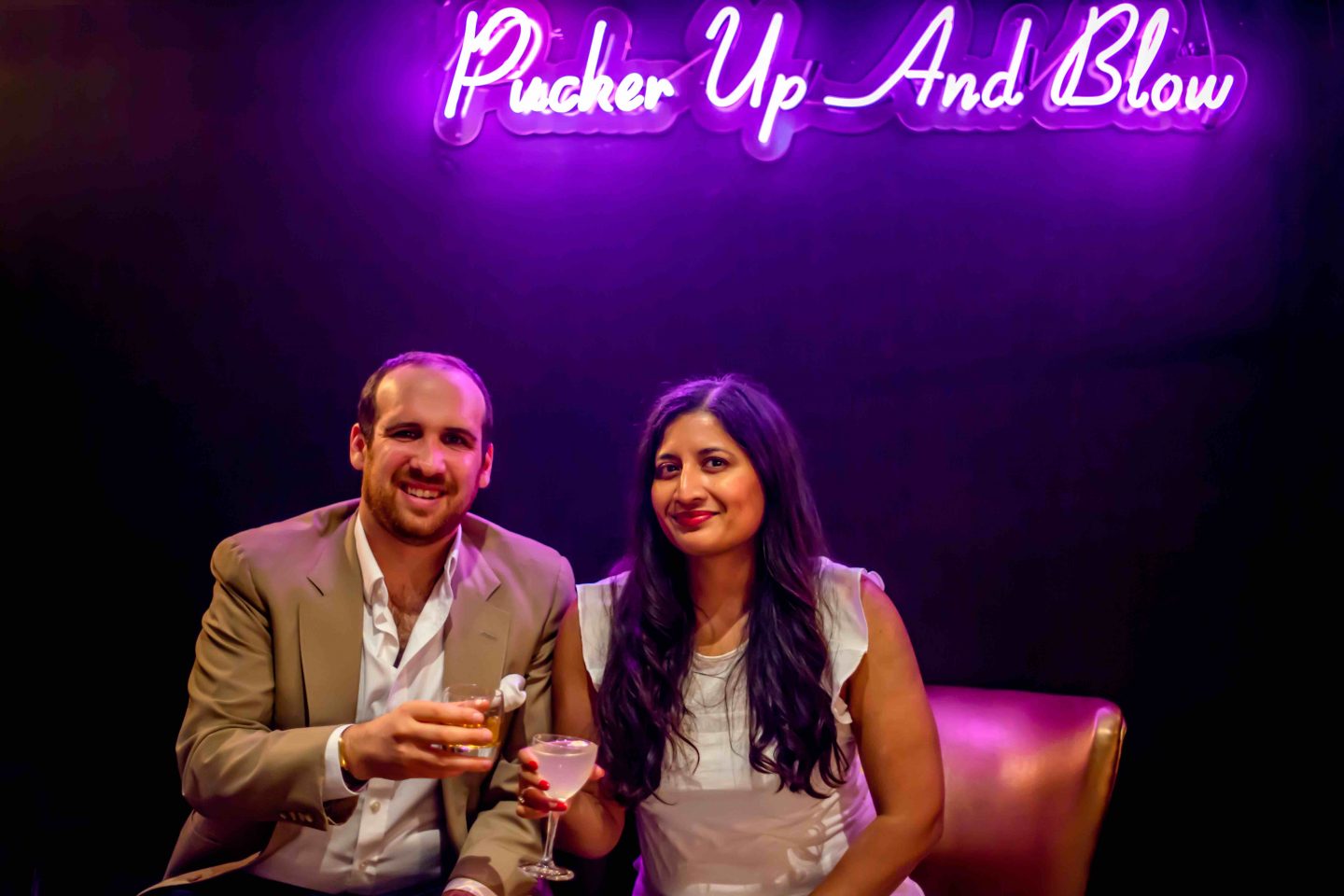 Best Cigar Bars in NYC in 2021: Merchants Cigar Bar Merchants Cigar Bar - Man and Woman with Cocktails. Best Cigar Bars in NYC.