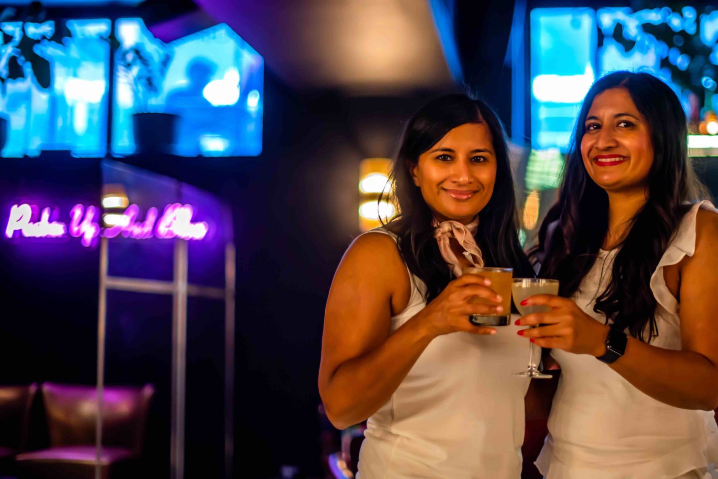 Best Cigar Bars in NYC in 2021: Merchants Cigar Bar Merchants Cigar Bar - Women Holding Drinks. Best Cigar Bars in NYC.