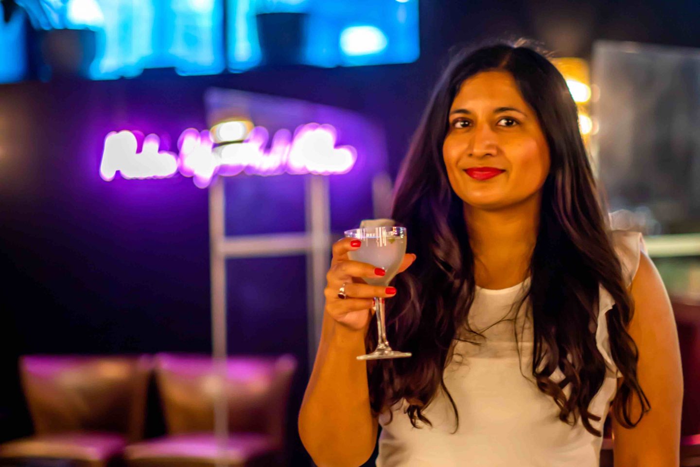 Best Cigar Bars in NYC in 2021: Merchants Cigar Bar Merchants Cigar Bar - Woman Holding a Drink. Best Cigar Bars in NYC.