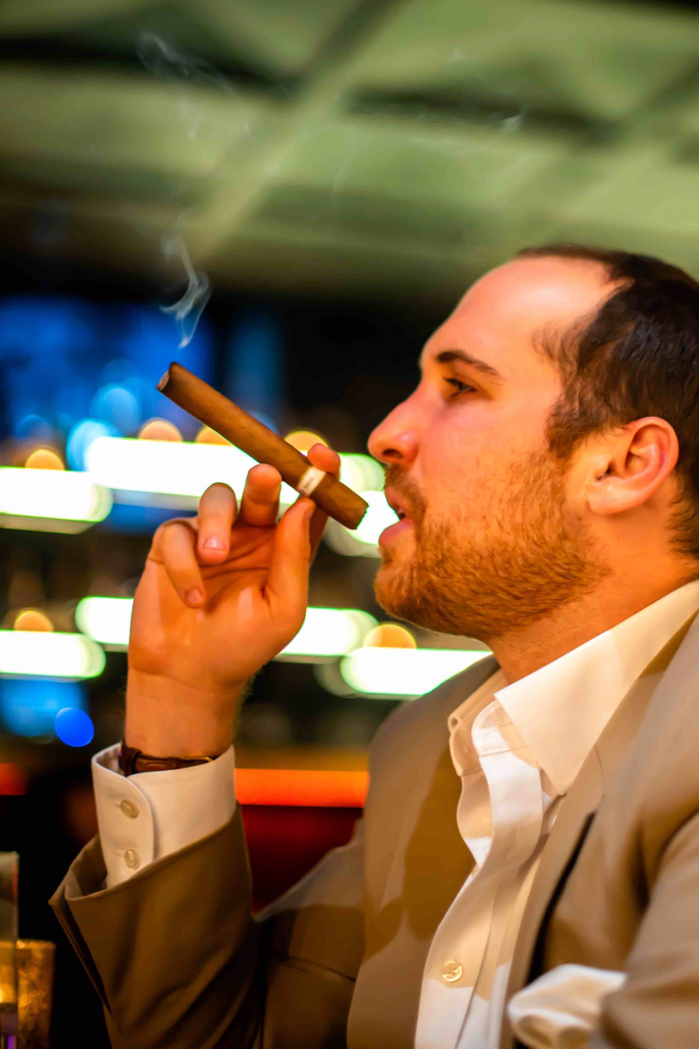 Best Cigar Bars in NYC in 2021: Merchants Cigar Bar Merchants Cigar Bar - Man Smoking a Cigar. Best Cigar Bars in NYC.