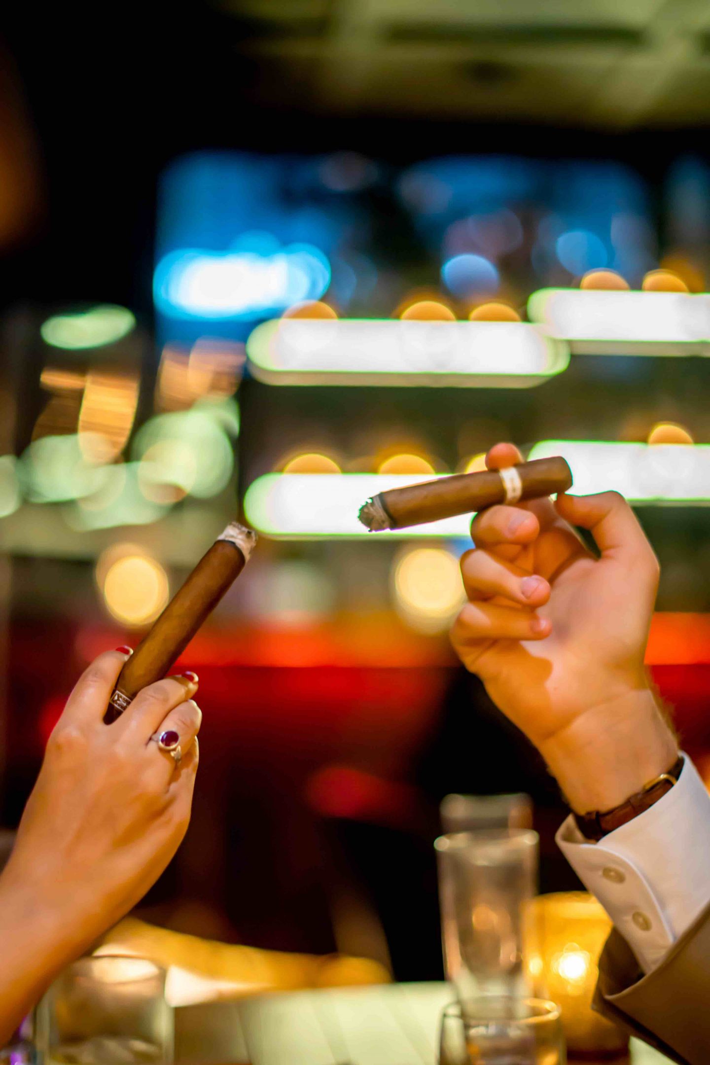 Best Cigar Bars in NYC in 2021: Merchants Cigar Bar Merchants Cigar Bar - Hands Holding Cigars. Best Cigar Bars in NYC.