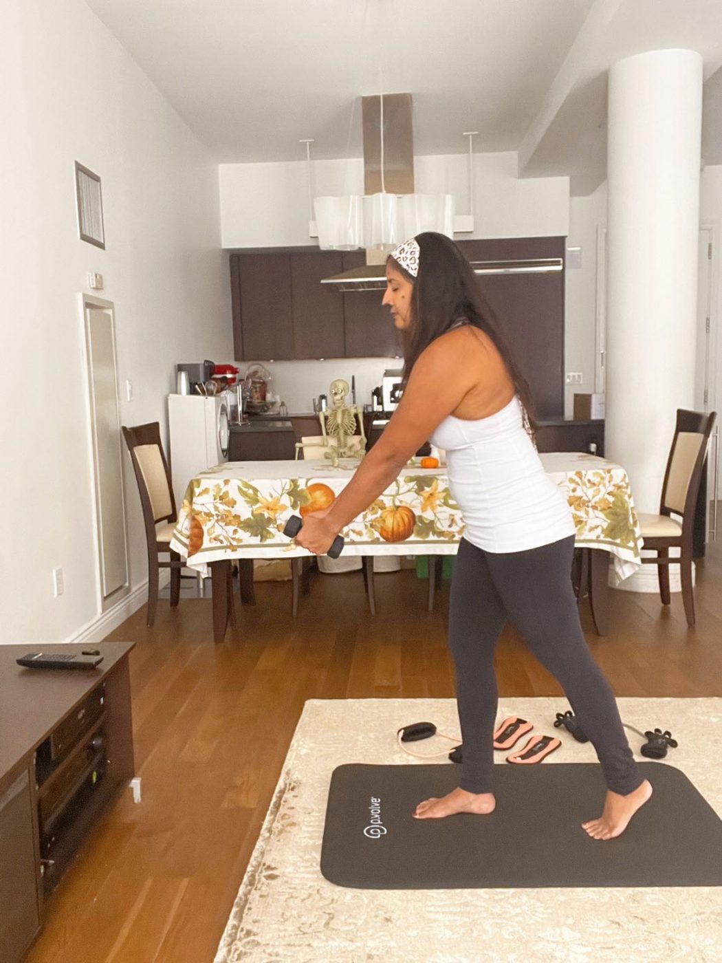 The Best Workouts at Home in Fall 2021: P.volve best workouts at home: P.volve. Halloween workout ideas. Light dumbbells.