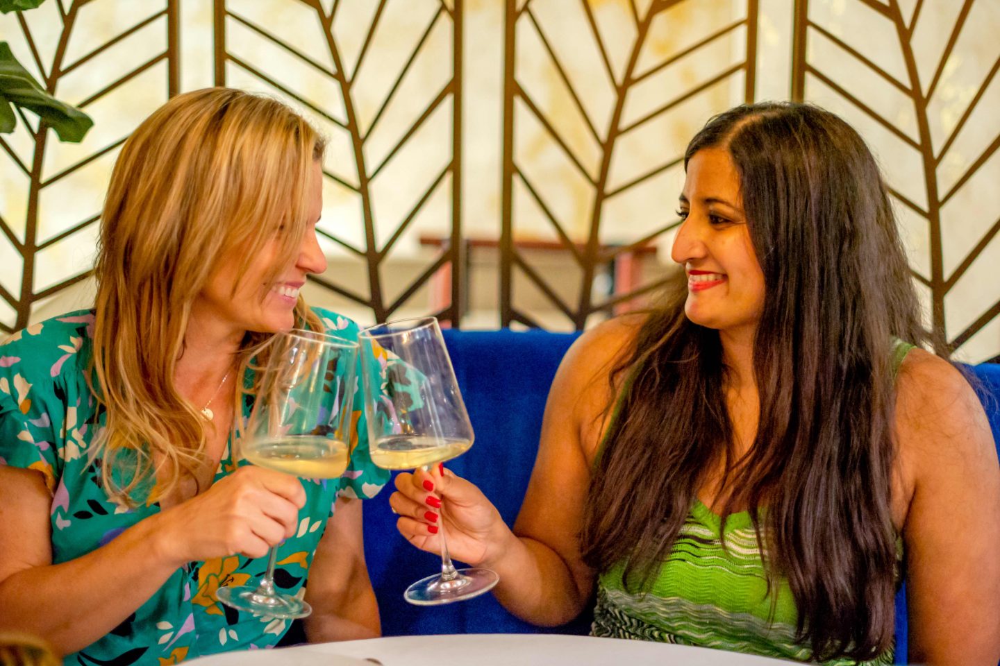 Casa Limone - women clinking glasses of white wine. Best Italian restaurants in midtown.