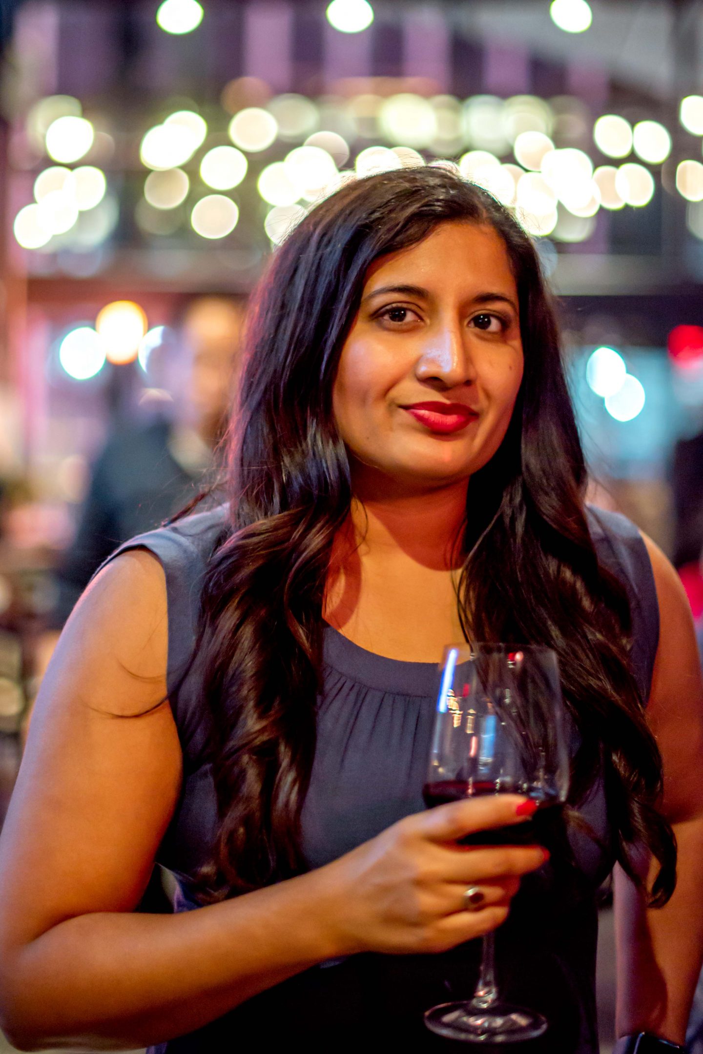 Versa Rooftop Woman Holding a Glass of Pinot Noir. Best Rooftops in Midtown Manhattan.