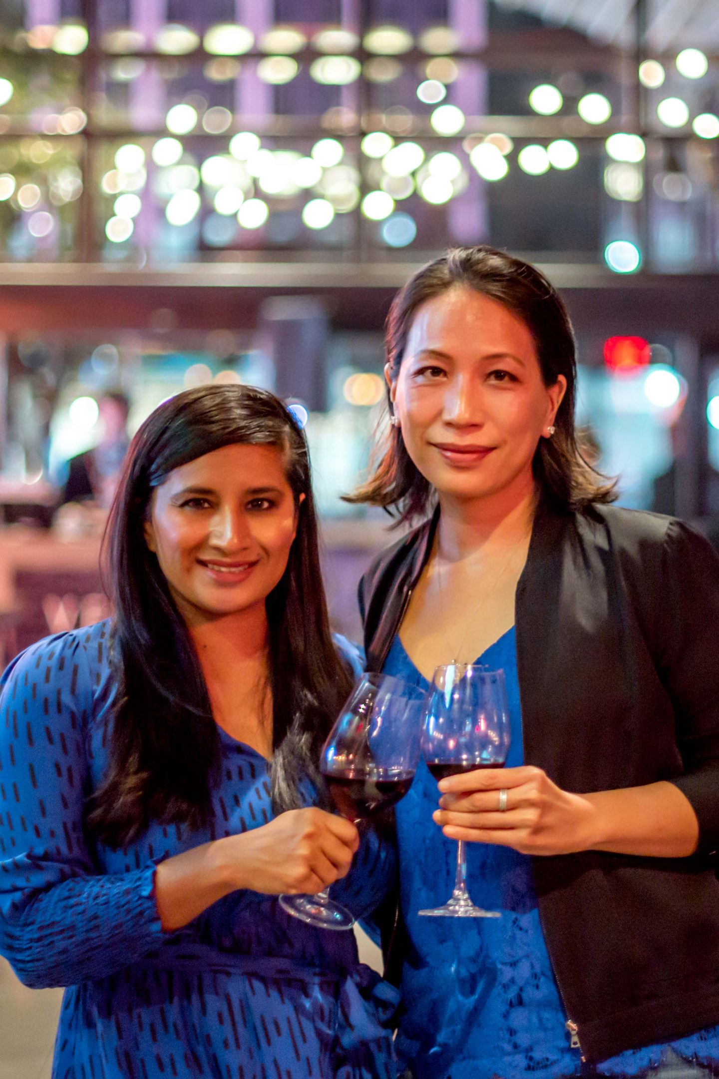 Versa Rooftop. Women Holding Glasses of Red Wine. Best Rooftops in Midtown Manhattan.