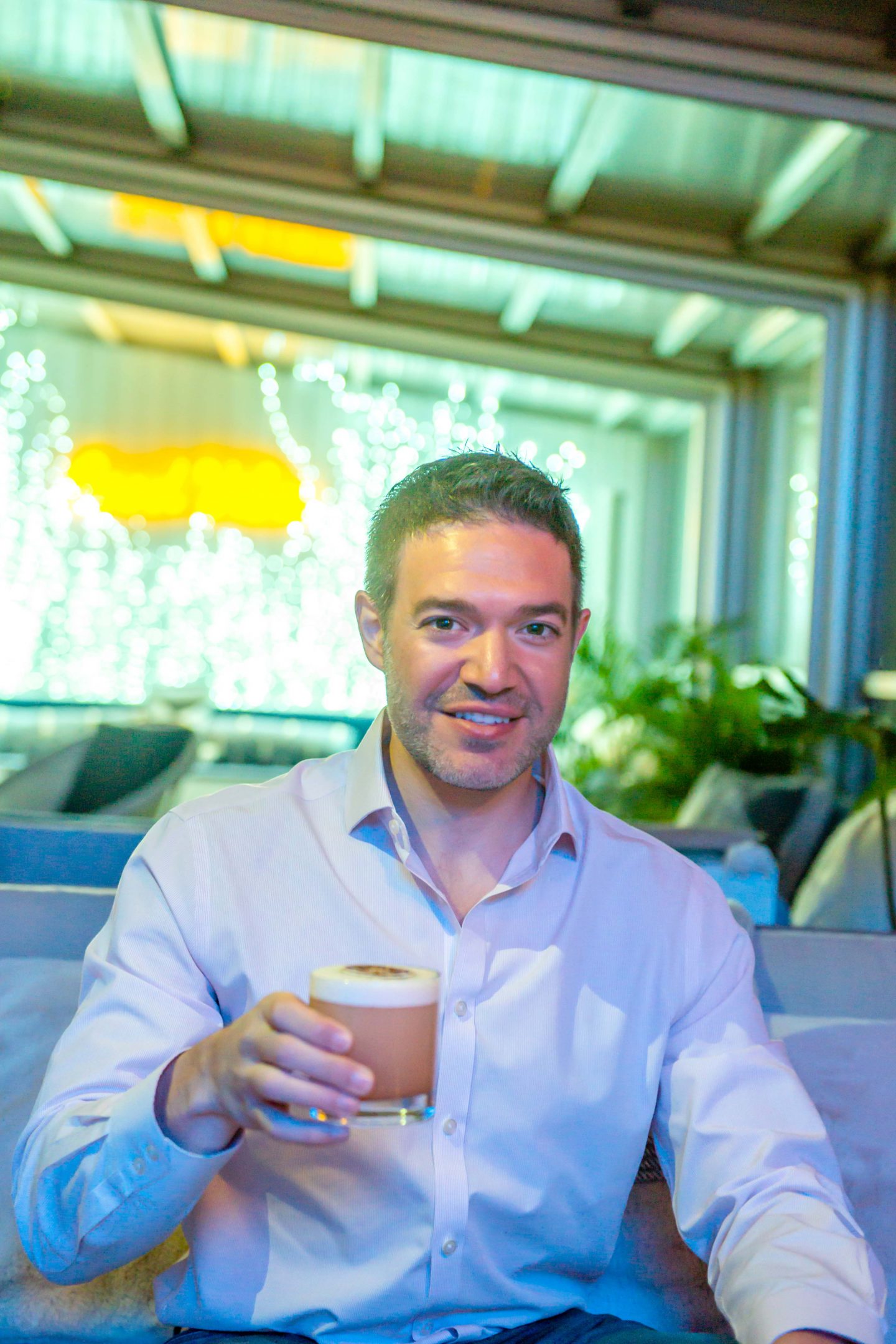 The Best Winter Rooftop Bars in NYC in 2022: Sandbar Sandbar Man Sipping a Cocktail. Best Winter Rooftop Bars in NYC. Sandbar Rooftop.