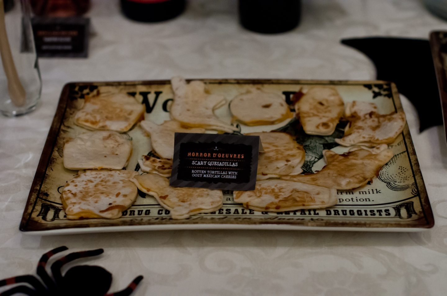 Halloween dinner party. Halloween table. Orange and black Halloween tablescape. Halloween quesadillas. 