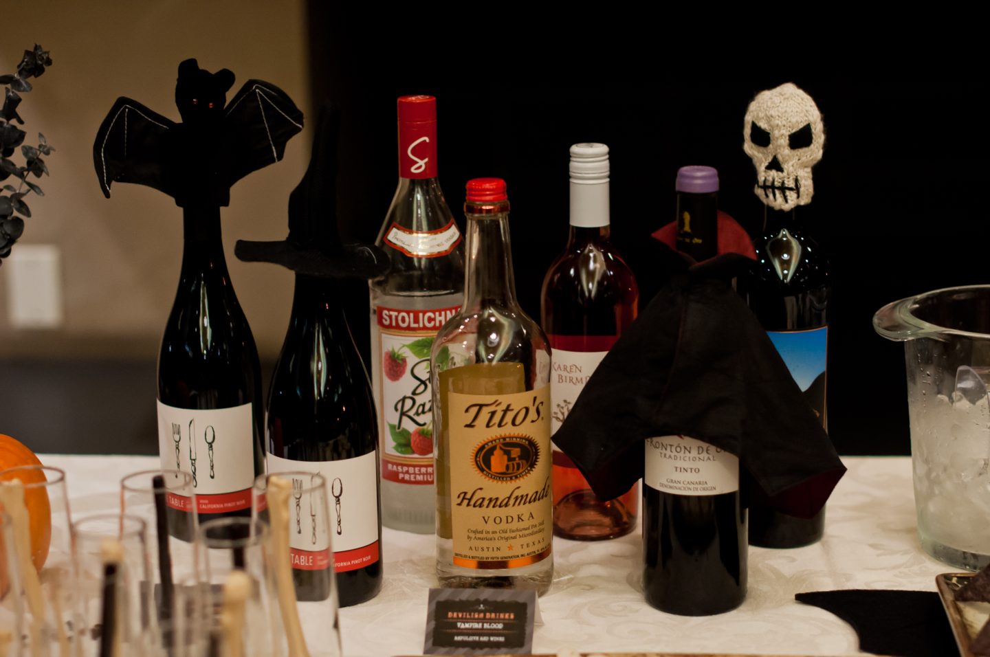 Halloween dinner party. Halloween bar. Orange and black Halloween tablescape.