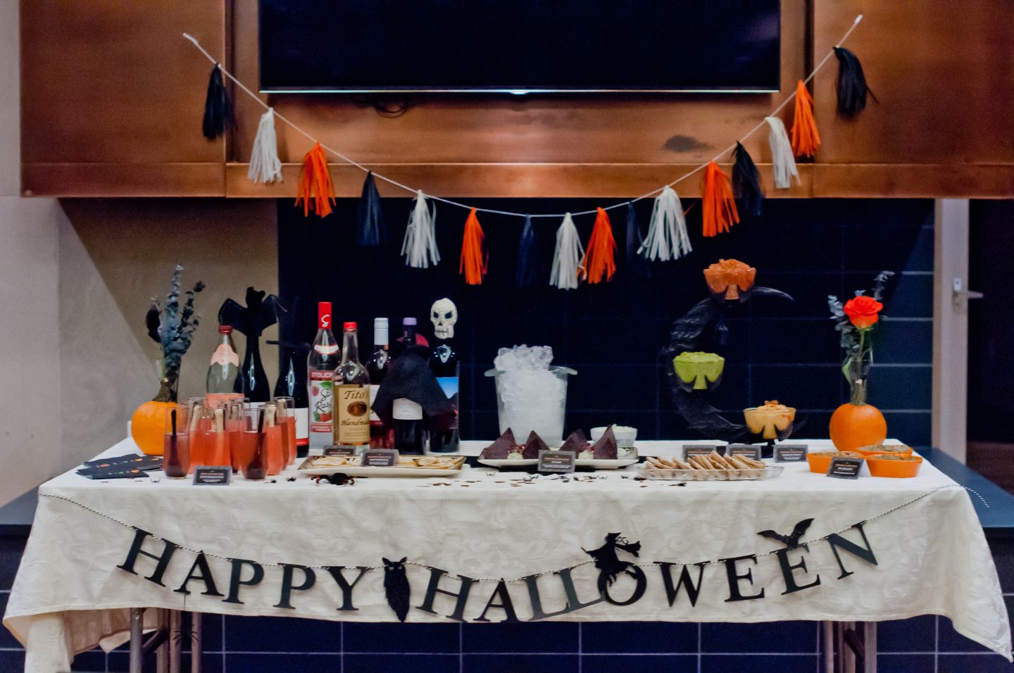 Halloween dinner party. Halloween bar. Orange and black Halloween tablescape.
