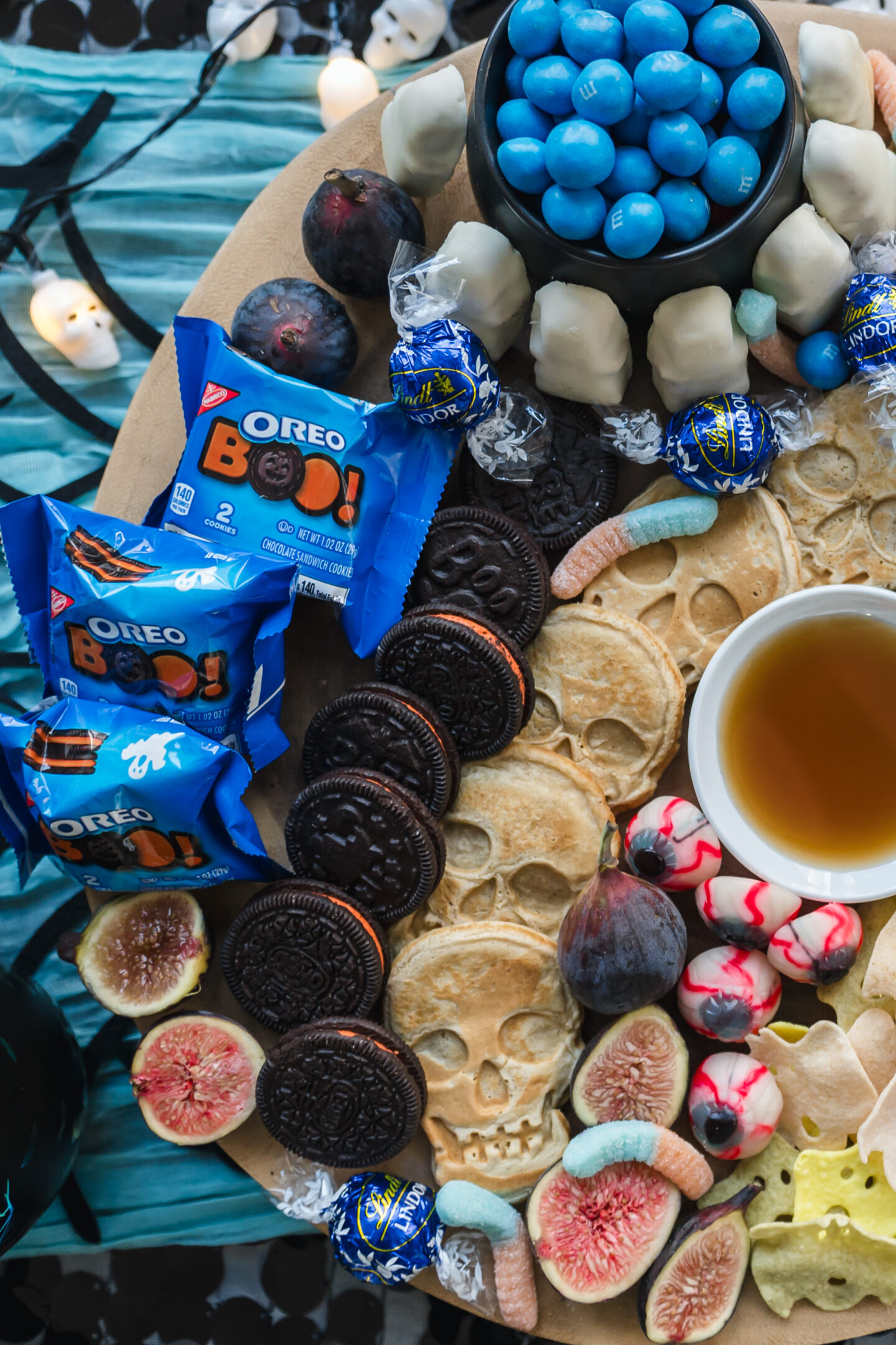 10 Stunning Black and Teal Halloween Party Ideas: Ghoulish Halloween Theme Ideas Teal Halloween Tablescape. Halloween Theme. Teal Brunch Board. Halloween Brunch Ideas.
