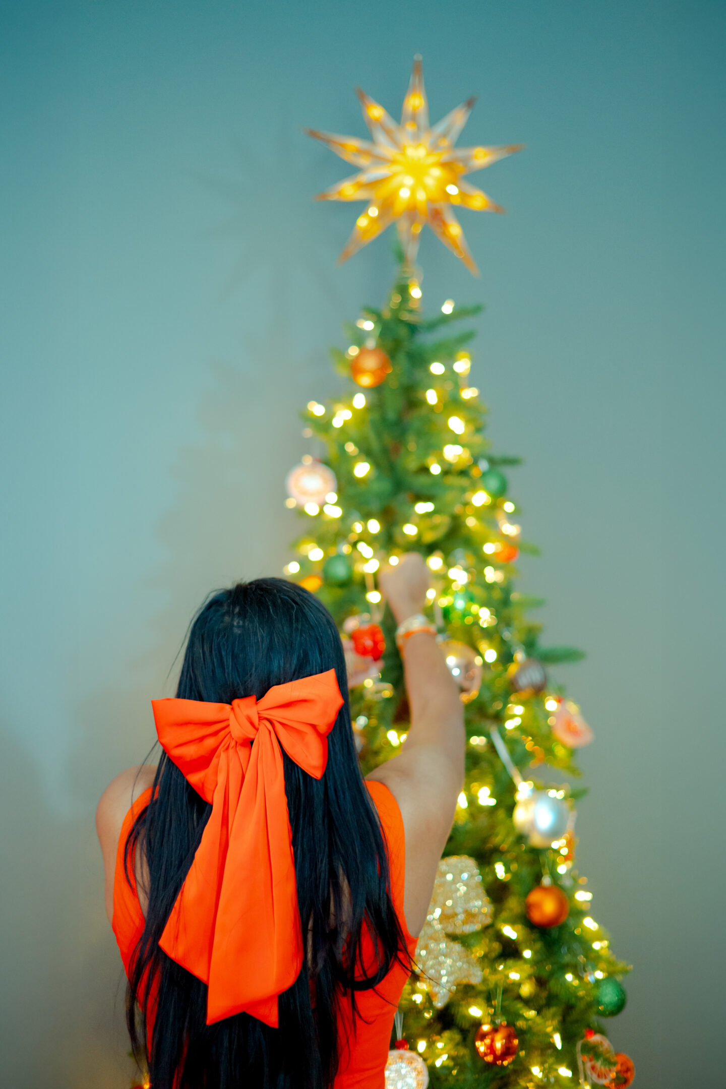 Best 5 Orange Christmas Party Ideas: The Ultimate Aperolidays Guide Lady decorating orange tree